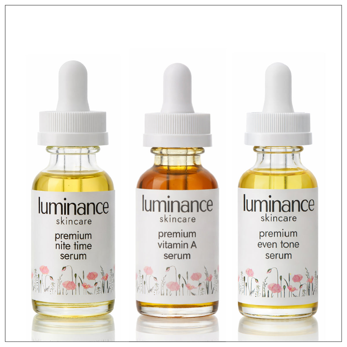 Three bottles of Luminance skincare serum on a white background